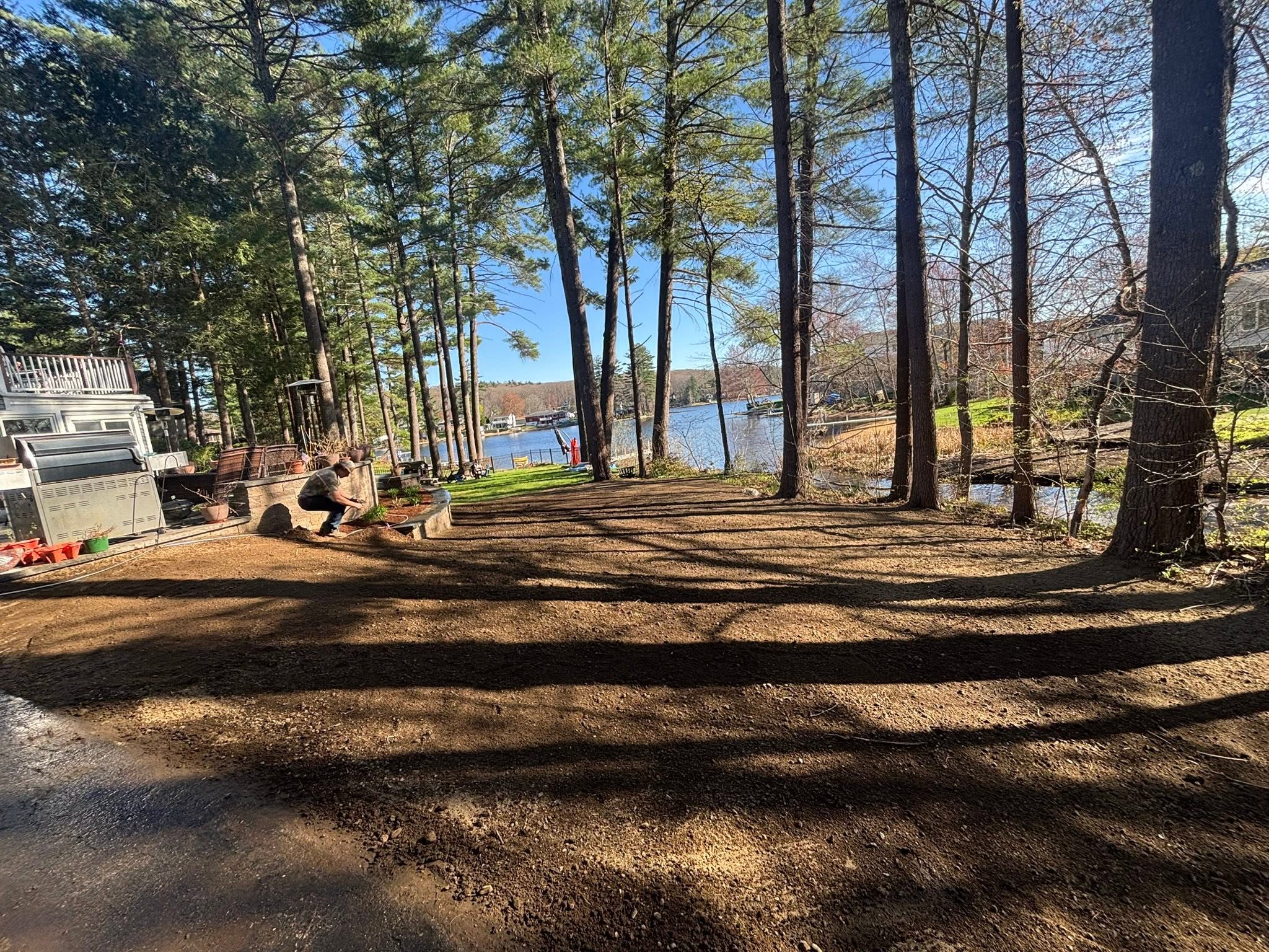 Finished backyard after concrete removal and loam spreading — Spencer, MA